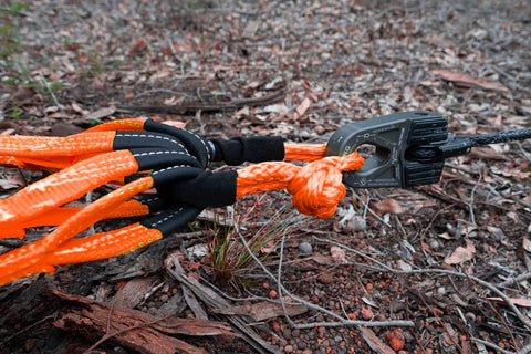Go-To Lightweight Soft Shackle Set 1/2 Inch By 24 Inch Recovery Shackles With Sleeves For Sailing SUV Off Road Towing And ATV 56,000 Lbs Breaking Strength Orange 2 Pack shown in use on rugged terrain