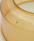 Close-up of Power Dome Replacement Part For Primo Grill Oven, vented design, amber color, heat resistant material.