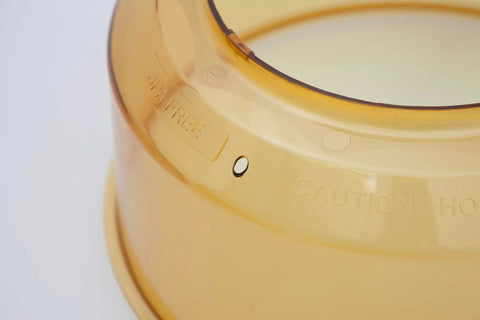 Close-up of Power Dome Replacement Part For Primo Grill Oven, vented design, amber color, heat resistant material.