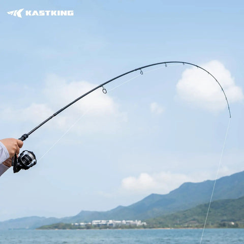 Person using Travel Ready 4 Piece Spinning And Casting Fishing Rods With Twin Tip at a scenic lake