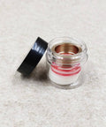 Seal assembly HP .875 for waterjet cutter; clear jar displaying red O-rings and copper inner ring