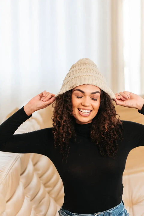 Woman wearing Satin Lined Beanie For Curly Hair Women Cozy Cable Knit Winter Hat With Frizz Free Moisture Retaining Satin Interior Curly