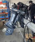 40 HP 2 Stroke Outboard Motor With Electric Start And Hydraulic Lift in workshop setting with visible components.
