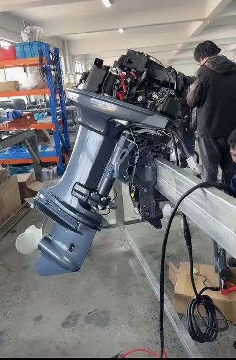40 HP 2 Stroke Outboard Motor With Electric Start And Hydraulic Lift in workshop setting with visible components.