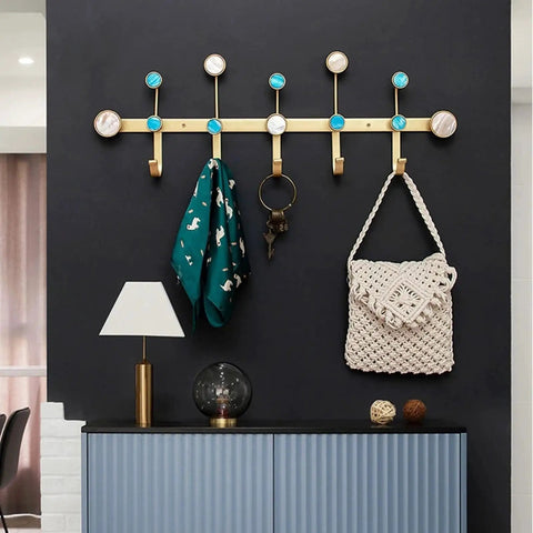 Heavy Hitter Wall Mounted Coat Hooks With Sleek Gold Iron Finish For Holding Coats Hats Keys And Jackets Super Sturdy No Fuss Setup Modern Bedroom Entryway Smart Storage Rack with teal scarf and bag.