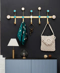Sturdy Rust Resistant Metal Coat Rack Wall Hooks With Lowkey Luxe Gold Finishing keeps scarves, keys, and bags organized on a wall.