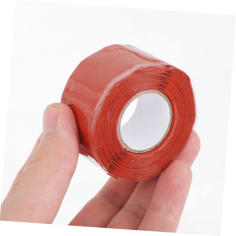 Hand holding red Leak Stop Tape For PVC PPR And Metal Pipes Flexible Self Adhesive Sealing Tape For Quick Waterproof Airtight Repairs
