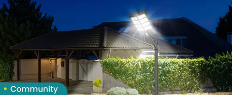 Super Bright 8000W LED Solar Street Light for Outdoor Security illuminating a driveway and yard at night with motion sensor