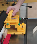 Hand using Knuckle Saver 3D Pushblock And One Eighth Inch Grip Leg Combo For Table Saw Safety on narrow wood stock.