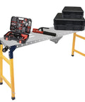 Badass Heavy Duty Portable Folding Welding Table and Smooth Rolling Workbench with tools and storage boxes on top.