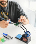 Heated 100W Soldering Iron Kit With LCD Temp Readout And Auto Sleep in use on PCB with tips, flux, tin wires, and helping hands