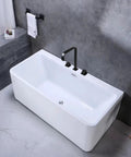 Matte black Roman Tub Faucet with 2 handles deck mount above a white bathtub, featuring 360 degree rotation and solid brass construction.