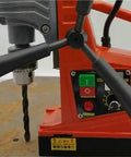 Compact Desktop Magnetic Drill Boasts Heavy-Duty Suction And Smooth Electric Forward Reverse Control For Industrial Tapping And Serious Grind Work On Your Home Shop Bench Or Job Site with visible controls and drill bit.