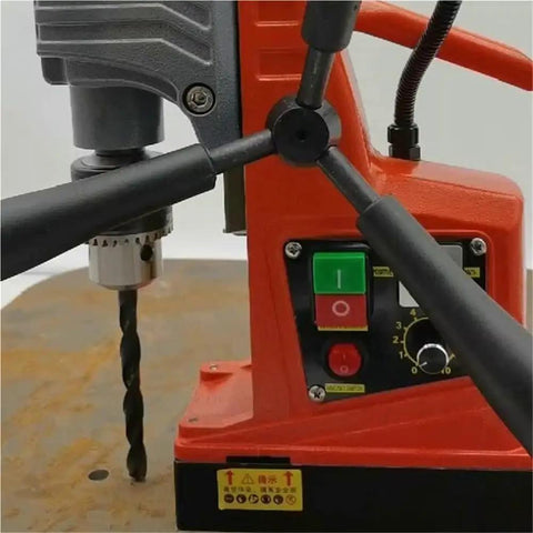 Compact Desktop Magnetic Drill Boasts Heavy-Duty Suction And Smooth Electric Forward Reverse Control For Industrial Tapping And Serious Grind Work On Your Home Shop Bench Or Job Site with visible controls and drill bit.