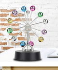 Battery Powered Newton Pendulum Ball Desktop Toy For Science Nerds with colorful swinging balls on black base