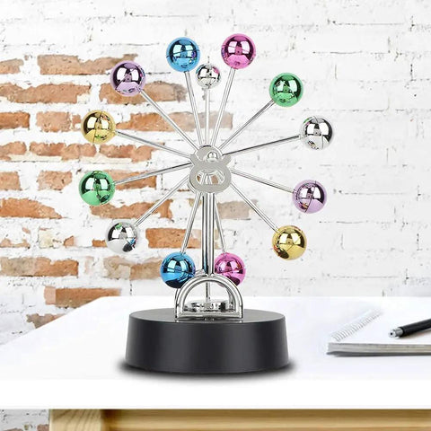 Battery Powered Newton Pendulum Ball Desktop Toy For Science Nerds with colorful swinging balls on black base