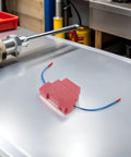 Automatic Fire Extinguisher Sticker For Car Engine Bay And Truck Self Activating Aerosol Fire Suppression Patch on a workshop table.