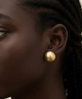 Bold Gold Round Earrings For Women Featuring A Chunky Wide Half Ball Design Lightweight Studs For Everyday Wear Dope Party Ready Glam Vibe Trendy Circle Hoop Look Essential Accessory For Chic Street Style, gold stud close-up