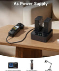 DJI WB37 Battery Charging Hub 72W USB C Fast Charger dual-channel with two batteries and remote controller on table