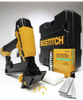 Yellow pneumatic flooring stapler with case, nails, and accessories on display.