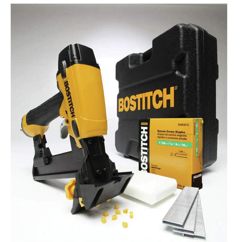 Yellow pneumatic flooring stapler with case, nails, and accessories on display.