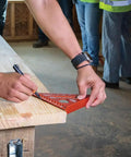 Seven Inch Double Laser Etched Aluminum Rafter Square With Badass Accuracy And No Hassle Multifunctional Carpenter Measuring Layout Tool featuring precise marking on wood surface.