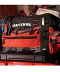 VersaStack Zippered Tool Bag With 31 Pocket Organizer, red and black, filled with tools, on a workbench