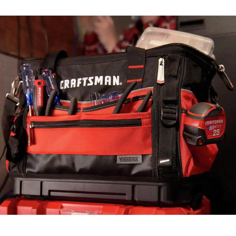 VersaStack Zippered Tool Bag With 31 Pocket Organizer, red and black, filled with tools, on a workbench