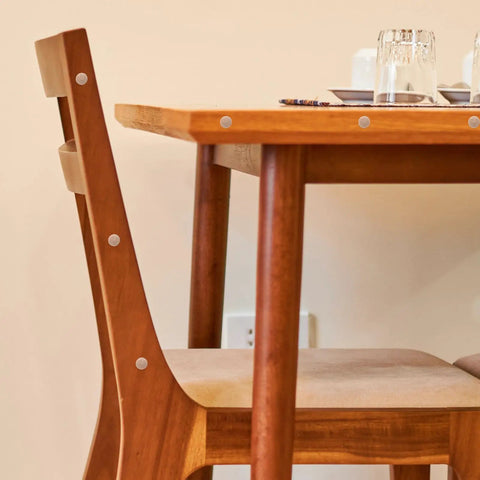 Tapered Wood Plugs For Screw Holes With Button Plug Head on a wooden chair and table, easy glue install, tight secure fit for DIY projects.