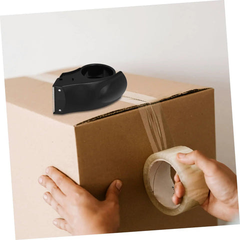Rock Solid Heavy Duty Tape Dispenser Cutter With Ergonomic Grip And Sharp Steel Blade For 5 Cm Packing Tape in use on a cardboard box.