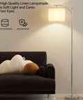 Arc Floor Lamp With Remote Control And Stepless Dimming, 9W Bulb, Adjustable Color Temperature beside couch
