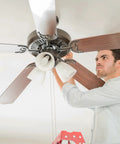 Man installing Heavy Duty Ceiling Fan Blade Screws 1/4-20 Inch By 3/8 Inch Carbon Steel Phillips Pan Head With Washers