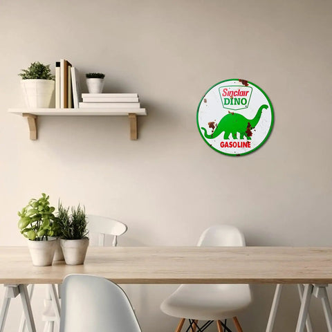 Badass Vintage Tin Sign Featuring Classic Sinclair Gasoline Poster Round Galvanized Metal Wall Art on a wall above a table.