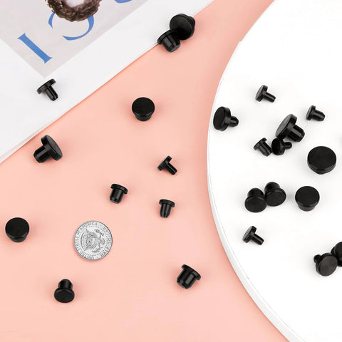 90 Pcs Silicone Rubber Hole Plugs Set In Assorted Sizes From 4mm To 9.5mm on pink background, showing black plugs and coin for scale.