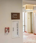 7 In 1 Fire Sprinkler Shutoff Tool Kit With Wall Cabinet Case for Pendant Sidewall and Recessed Heads in a hotel corridor.