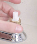 Hand installing 1224 Replacement Faucet Cartridge Kit For Double Handle Faucets And Tub Showers into a faucet.