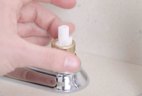 Hand installing 1224 Replacement Faucet Cartridge Kit For Double Handle Faucets And Tub Showers into a faucet.
