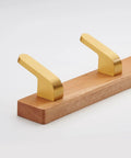 No Fuss Brass Wall Mount Coat Hooks Durable Entryway Hanger Rack with three curved hooks on wooden base.