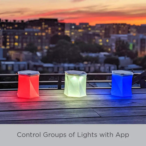 Bloomio Twist Solar Camping Lantern With Bluetooth App Control And Multicolor Led Lights on rooftop at sunset