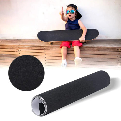 Child holding skateboard with Anti Slip Grip Tape For Skateboards And Scooters, Waterproof Outdoor Tape in 9 by 33 Inches, thick black roll