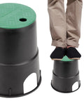 Six Pack Six Inch Underground Electrical Splice Box For Outdoor Wiring, black polypropylene with green lid. Man standing on box.