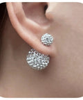 Rhinestone Double Ball Stud Earrings Set With Sparkling Crystal Orbs Clear Light Blue Royal Blue Pink And Multicolor Disco Ball Finishes Hypoallergenic Jewelry for Women Everyday Bling for Sensitive Ears 16mm by 8mm close-up on ear