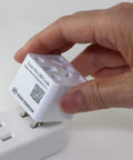 Person holding Must Have US Type A Travel Plug Adapter Converts European UK Indian Australian Chinese Brazilian And Other Plug Types To USA Outlets 2 Prong Ungrounded Travel Converter For North America close to an outlet