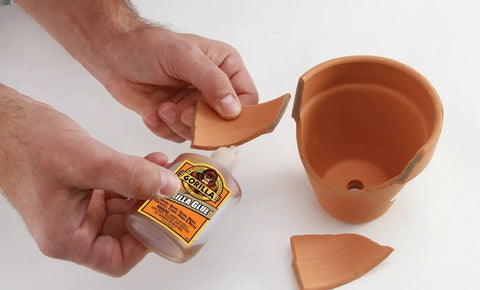 Heavy Duty Waterproof Polyurethane Glue In Rich Brown used to bond ceramic pot fragments, demonstrating effective repair capabilities.