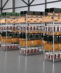 4 Tier Stainless Steel Storage Rack Heavy Duty Utility Shelf With Sweet Rolling Casters And No Hassle Adjustable Height For Kitchen Garage Office Space Saving Wire Shelving Rack filled with boxes and containers in a warehouse.