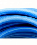 Close-up of blue Heavy Duty Compressed Air Piping Connectors Fit For Workshop Featuring Anti Marring Steel Inner Construction Brass Ends For Smooth Up To 300 PSI Flexibility Rock Solid Build Great For Garage Repairs Getting Stuff Done Fast When Needed.