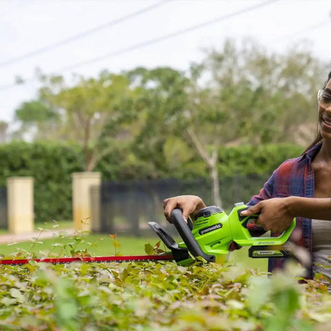 Person using Cordless 24V Hedge Trimmer With 22 Inch Laser Cut Blades, Dual Action Steel, 4Ah Battery And USB Charger Included