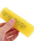 Forty Heavy Duty Paint Texture Sponge Rollers For Nailing Perfect Embossed Wall Finishes On Gnarly Surfaces With An Elastic Grip, yellow sponge roller held in hand.