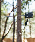 60Ft Zipline Brake System With Heavy Duty Bungee Cords And Plastic Brake Block installed on a zipline in a forest setting