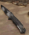 Black Serrated Folding Knife With Dual Edge Design For Outdoor Camping, Fishing And Hunting on wooden surface